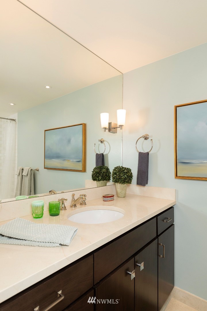 1301 Spring Street, Unit 18J Seattle, WA 98104 - Photo 20 of 25 a bathroom with a sink and a mirror