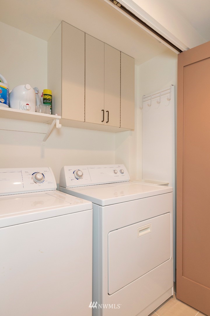 1301 Spring Street, Unit 18J Seattle, WA 98104 - Photo 22 of 25 a utility room with dryer and washer