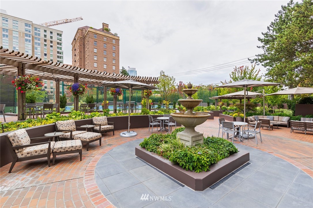 1301 Spring Street, Unit 18J Seattle, WA 98104 - Photo 25 of 25 a view of a patio with a table and chairs