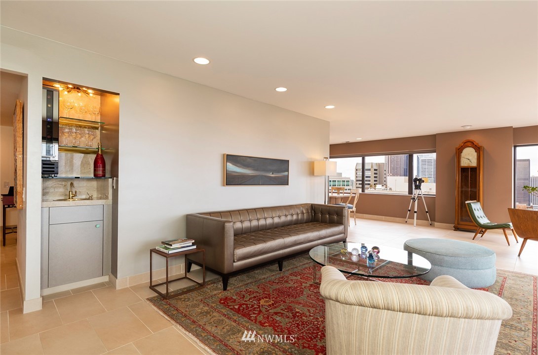 1301 Spring Street, Unit 18J Seattle, WA 98104 - Photo 4 of 25 a living room with furniture and a potted plant