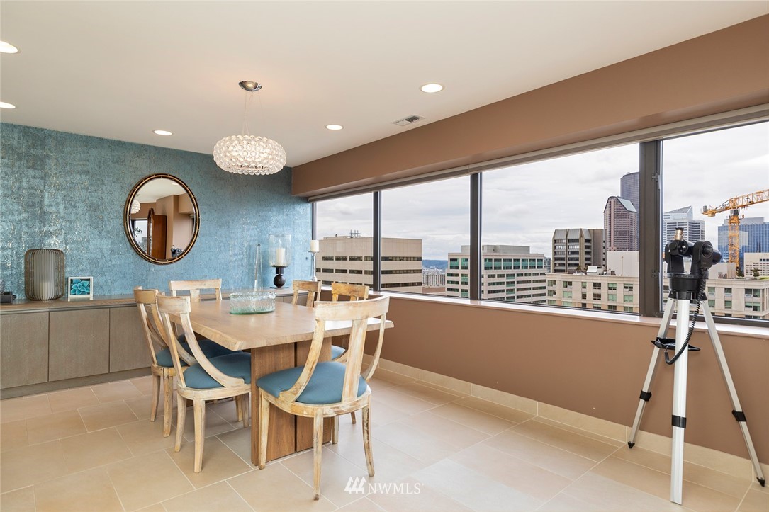 1301 Spring Street, Unit 18J Seattle, WA 98104 - Photo 7 of 25 a view of a dining room with furniture and a large window