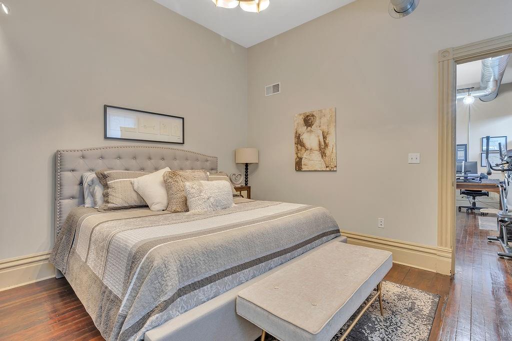 5202 Butler Street, Unit 1 Pittsburgh, PA 15201 - Photo 15 of 28 a bedroom with a bed and a night stand