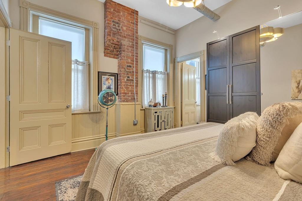 5202 Butler Street, Unit 1 Pittsburgh, PA 15201 - Photo 17 of 28 a bedroom with a bed and wooden floor