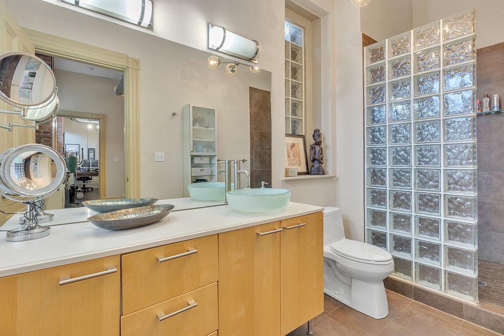 5202 Butler Street, Unit 1 Pittsburgh, PA 15201 - Photo 18 of 28 a bathroom with a sink a toilet and a mirror