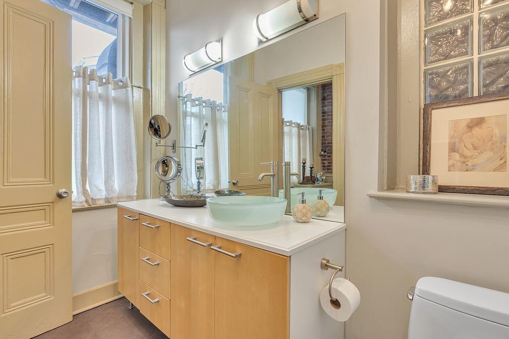 5202 Butler Street, Unit 1 Pittsburgh, PA 15201 - Photo 19 of 28 a bathroom with a double vanity sink mirror and toilet