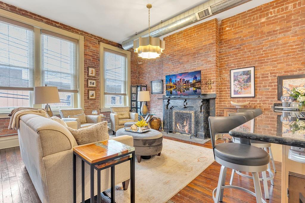 5202 Butler Street, Unit 1 Pittsburgh, PA 15201 - Photo 3 of 28 a living room with fireplace furniture and a flat screen tv