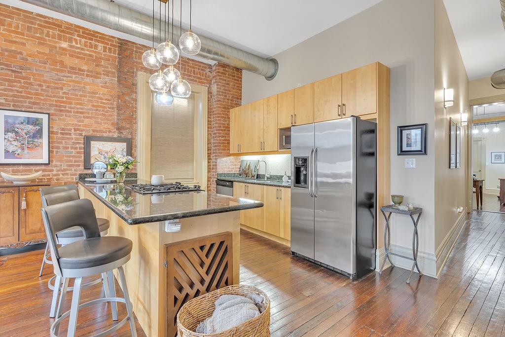 5202 Butler Street, Unit 1 Pittsburgh, PA 15201 - Photo 8 of 28 a kitchen with a refrigerator a sink and chairs