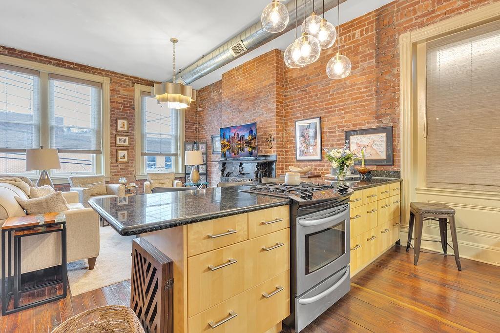 5202 Butler Street, Unit 1 Pittsburgh, PA 15201 - Photo 10 of 28 a kitchen with stainless steel appliances granite countertop a stove and a refrigerator