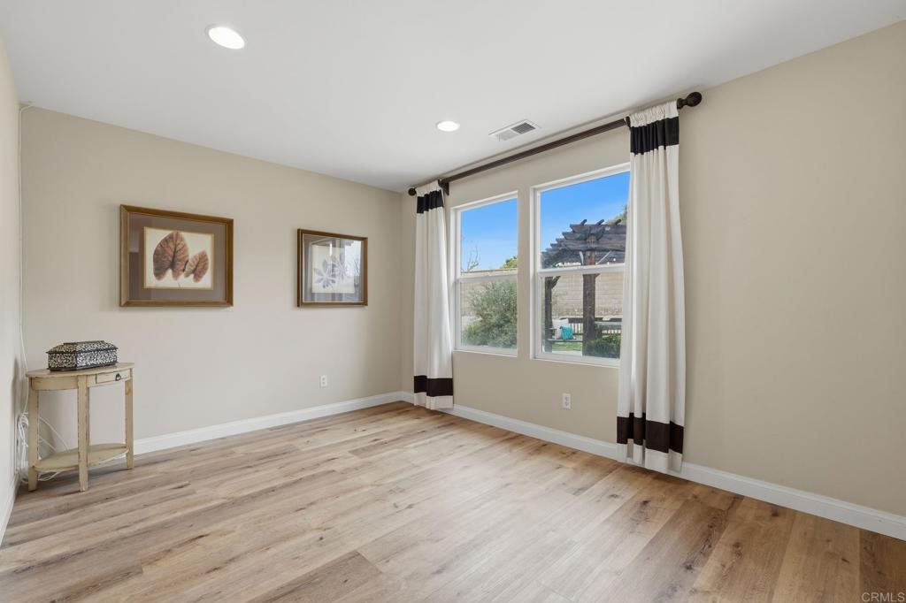 321 William Pittenger Place Fallbrook, CA 92028 - Photo 12 of 32 a view of an empty room with a window and wooden floor
