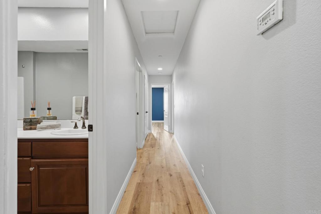 321 William Pittenger Place Fallbrook, CA 92028 - Photo 16 of 32 a view of a hallway with a sink and a refrigerator
