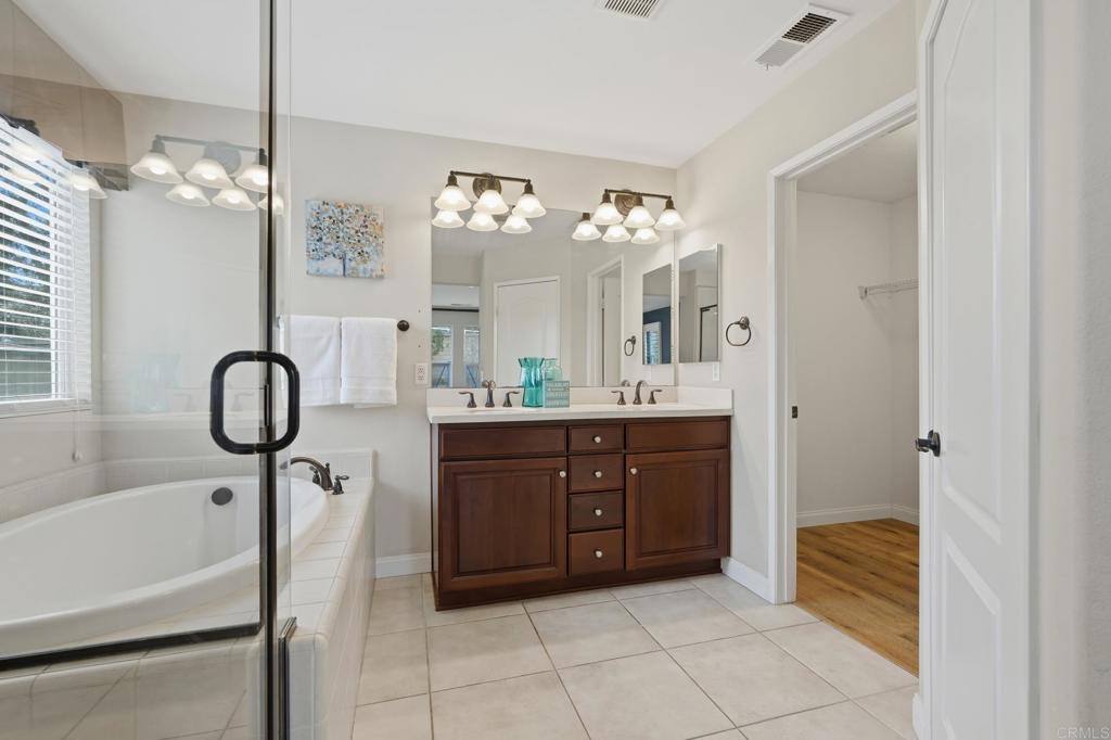 321 William Pittenger Place Fallbrook, CA 92028 - Photo 8 of 32 a spacious bathroom with a sink a mirror and a bathtub