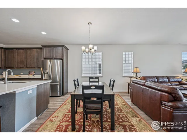 a kitchen with kitchen island a sink table and chairs