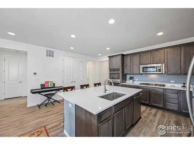 a kitchen with a sink a counter top space and stainless steel appliances
