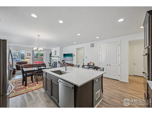 a kitchen view with furniture a refrigerator and a sink