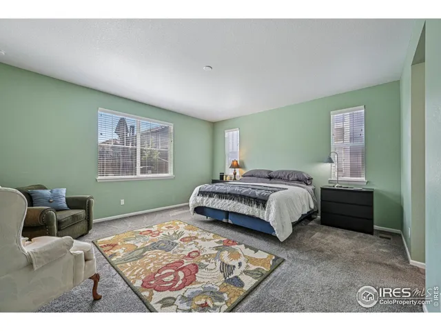 a bedroom with a bed and a mirror