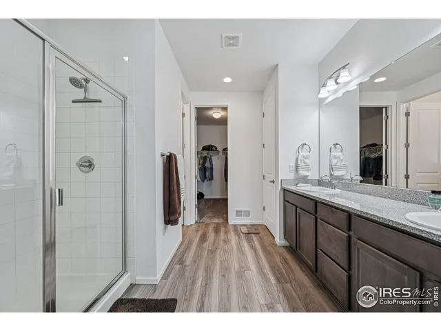 a bathroom with a double vanity sink and mirror