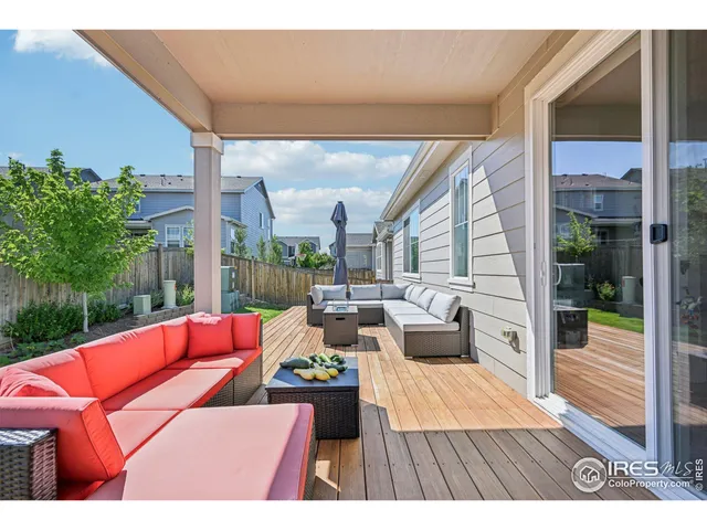 a outdoor sitting area with furniture and wooden floor