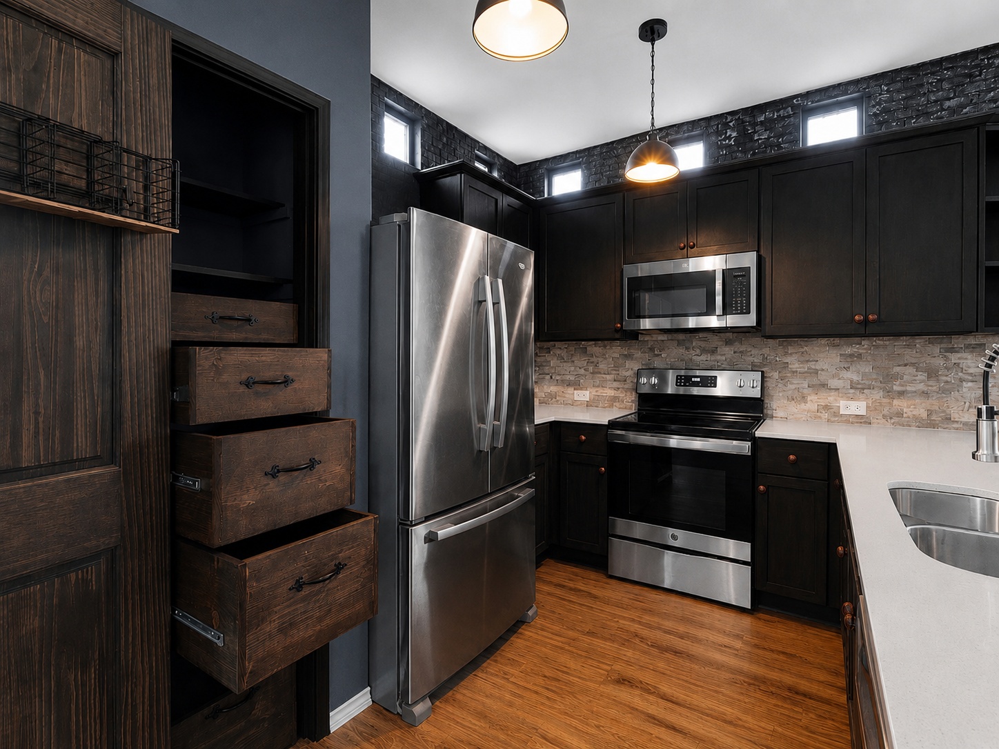116 Night Riders Way Jarrell, TX 76537 - Photo 16 of 37 An inviting kitchen showcasing sleek dark cabinetry and gleaming stainless steel appliances.