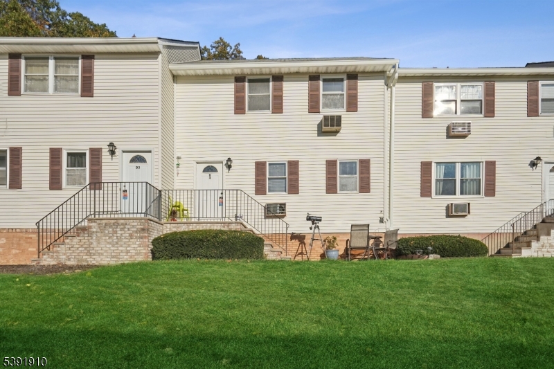 a front view of house with yard and outdoor seating