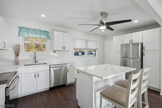a kitchen with appliances a sink and cabinets