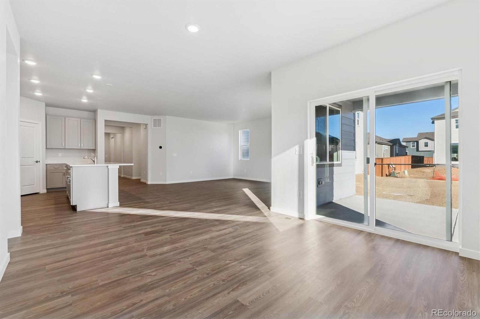 1446 Farmstead Street Brighton, CO 80601 - Photo 12 of 26 a view of empty room with wooden floor
