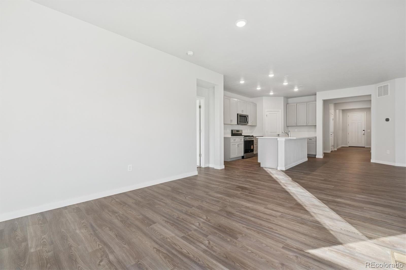 1446 Farmstead Street Brighton, CO 80601 - Photo 13 of 26 a view of kitchen with wooden floor