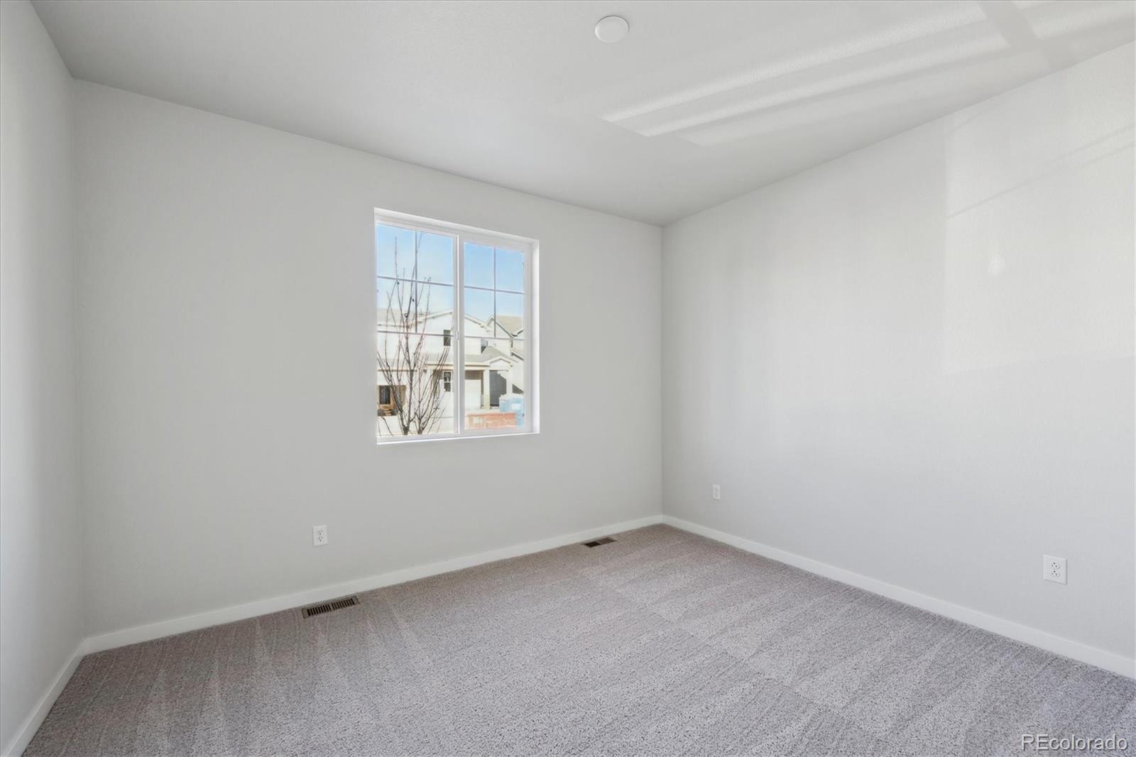 1446 Farmstead Street Brighton, CO 80601 - Photo 15 of 24 an empty room with a window