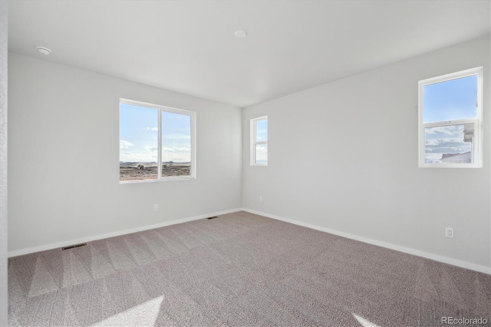 1446 Farmstead Street Brighton, CO 80601 - Photo 17 of 24 an empty room with windows