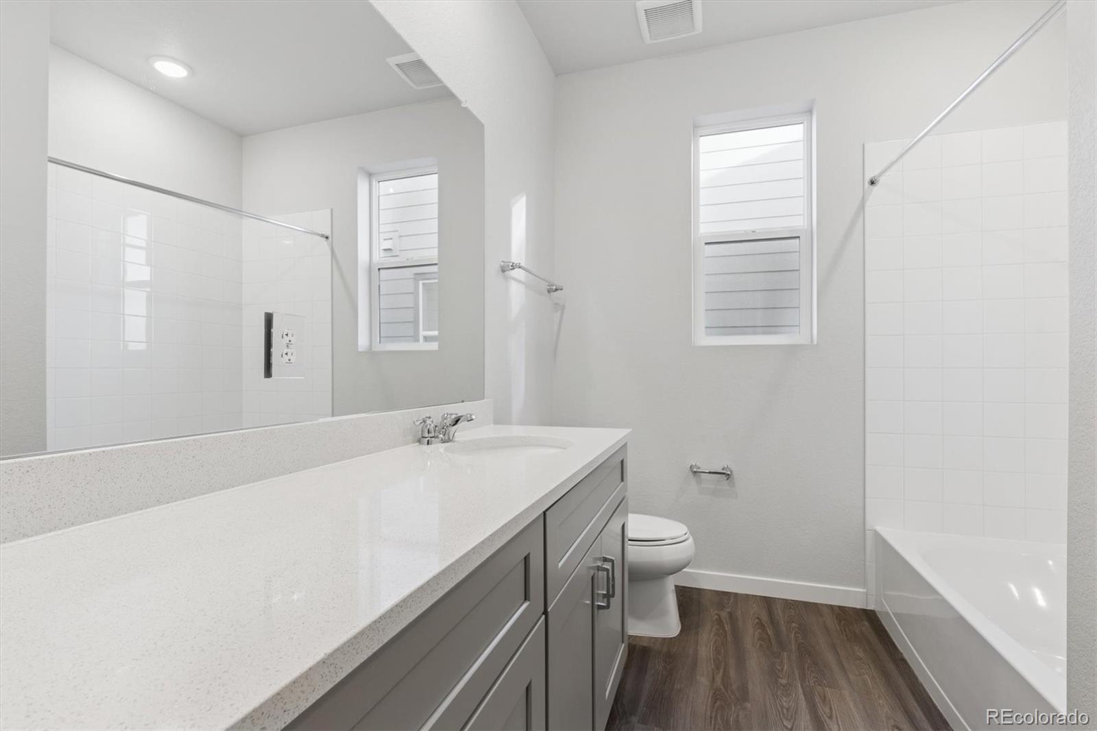 1446 Farmstead Street Brighton, CO 80601 - Photo 17 of 26 a bathroom with a sink a toilet and a window