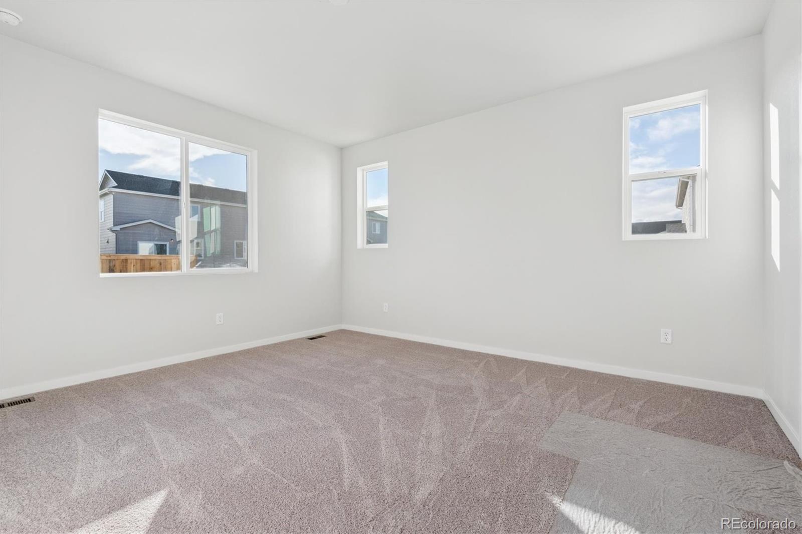 1446 Farmstead Street Brighton, CO 80601 - Photo 21 of 26 an empty room with windows