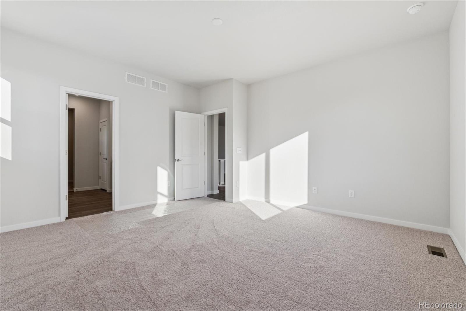1446 Farmstead Street Brighton, CO 80601 - Photo 22 of 26 a view of an empty room with closet and a window