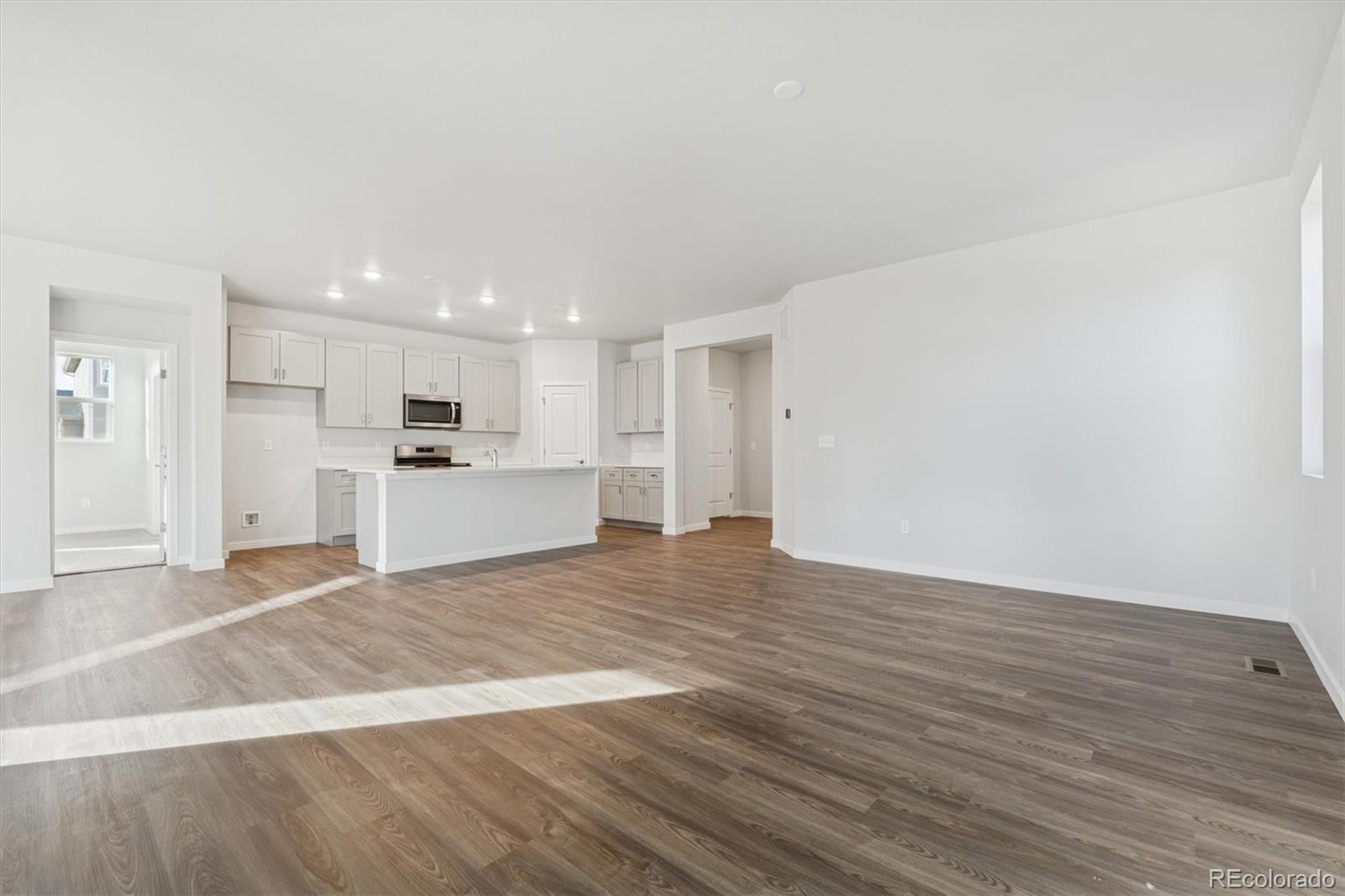 1446 Farmstead Street Brighton, CO 80601 - Photo 7 of 26 a view of a kitchen with a sink and a stove top oven