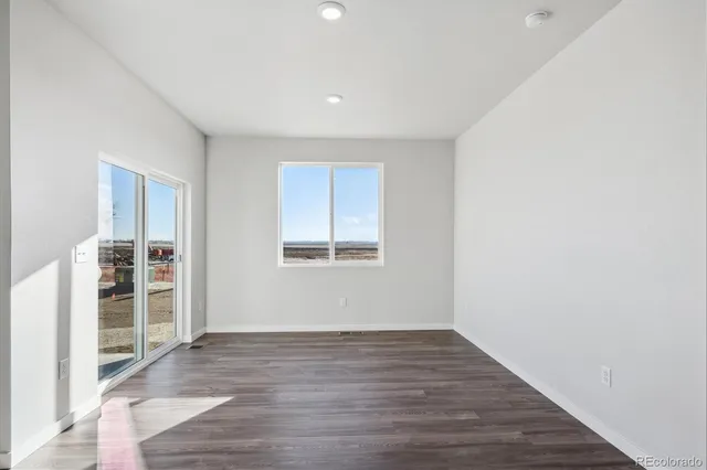 a view of wooden floor and windows in a room