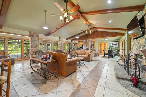 a living room with lots of furniture and a large window