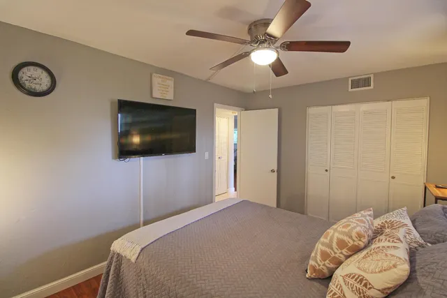 a bedroom with a bed and a flat screen tv