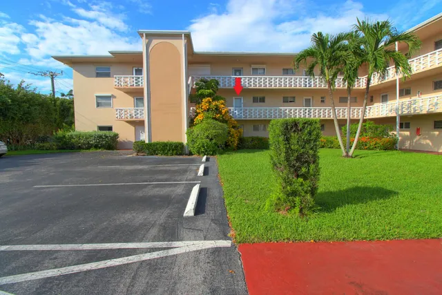 a front view of building with garden