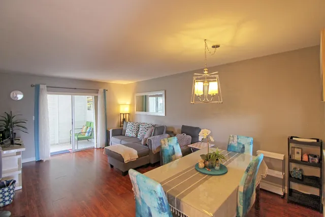 a living room with furniture and a chandelier