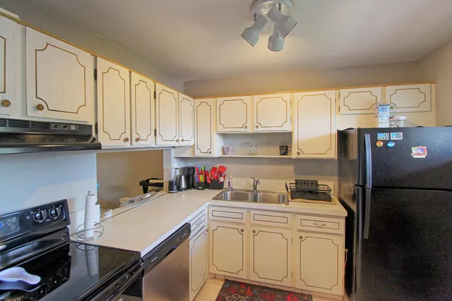 a kitchen with a sink appliances and cabinets