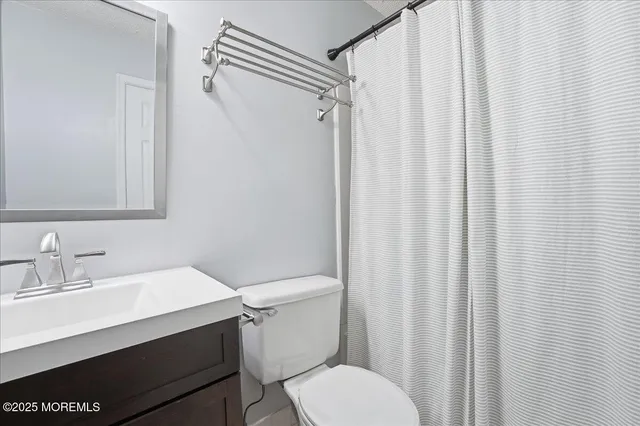 a white toilet sitting next to a bathroom sink
