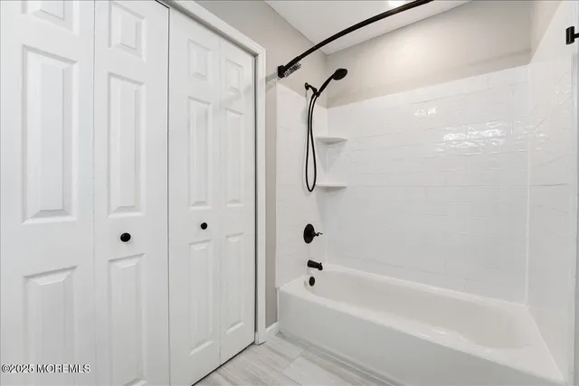 a bathroom with a shower and a bath tub