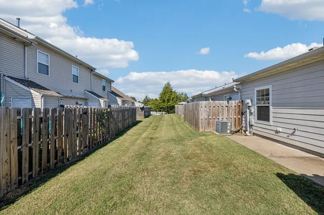 a view of a house with a backyard