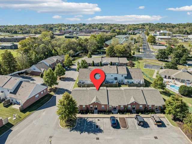 an aerial view of a house with a yard and lake view