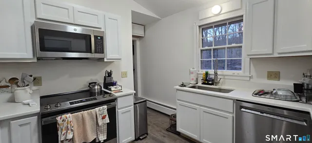 a kitchen with a sink stove and microwave