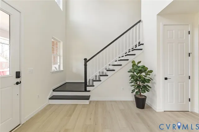 a view of entryway and hall with wooden floor