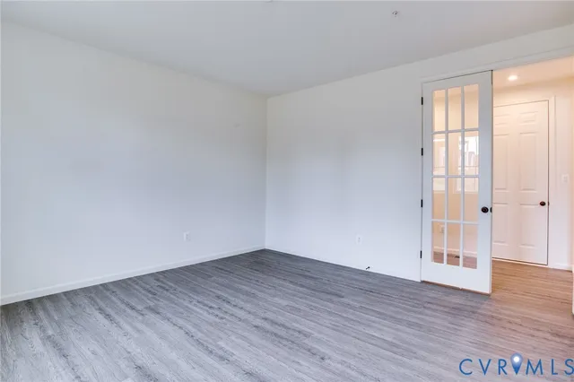 an empty room with windows and entrance