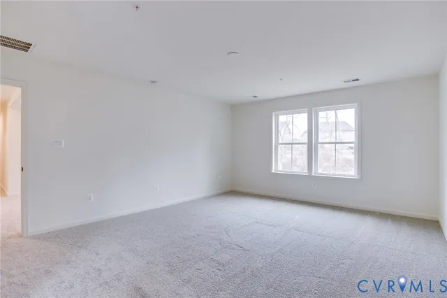 a bathroom with a toilet a sink a mirror and a window