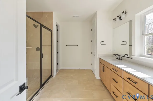 a spacious bathroom with a double vanity sink mirror double and shower