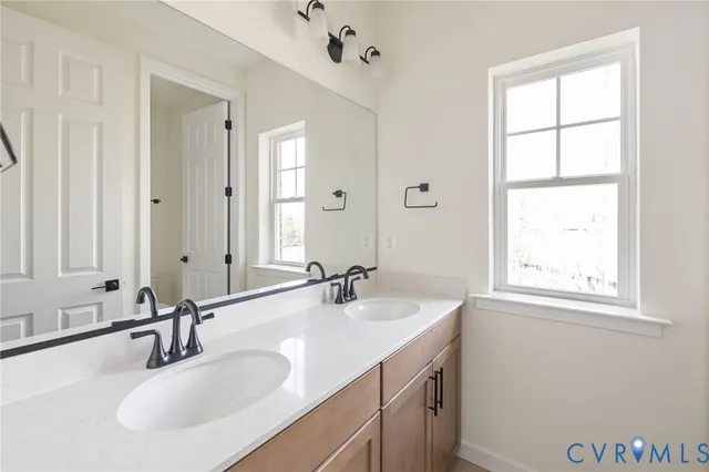 a bathroom with 2 sink and a mirror