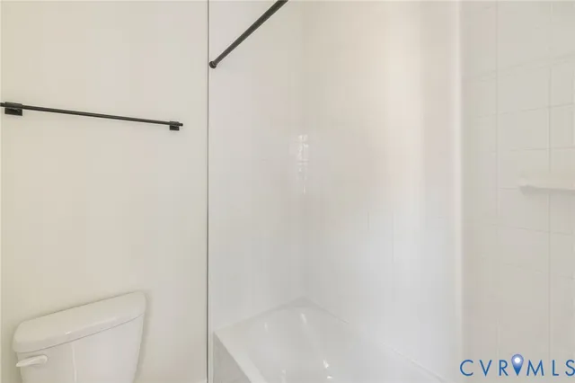 a bathroom with a shower and a toilet