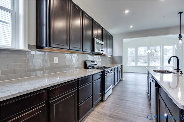 a kitchen with stainless steel appliances granite countertop counter space a sink and cabinets